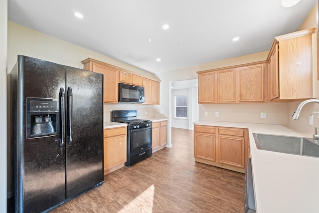 kitchen with light hardwood / wood-style flooring, black appliances, and sink