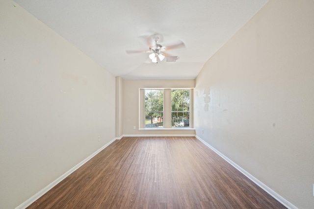 spare room with dark hardwood / wood-style flooring, ceiling fan, and vaulted ceiling