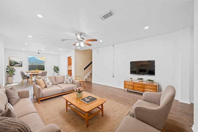 living room with ceiling fan and light hardwood / wood-style floors