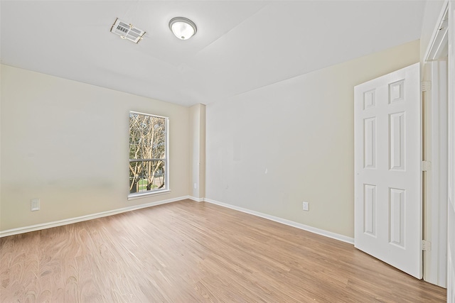 empty room with light hardwood / wood-style flooring