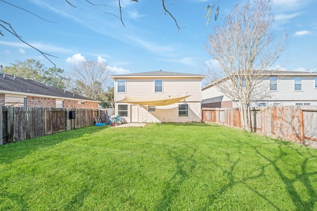 back of house featuring a yard