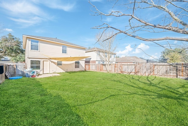 rear view of property with a yard