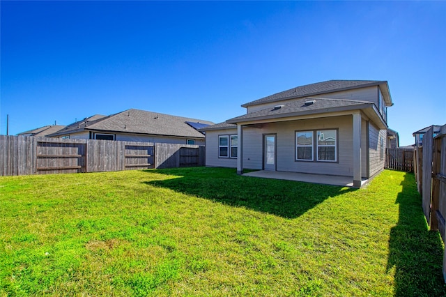 back of house featuring a lawn and a patio area