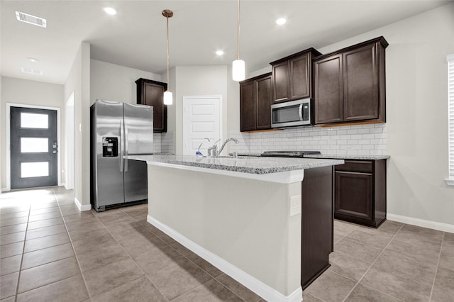 kitchen featuring sink, decorative light fixtures, light tile patterned floors, backsplash, and appliances with stainless steel finishes