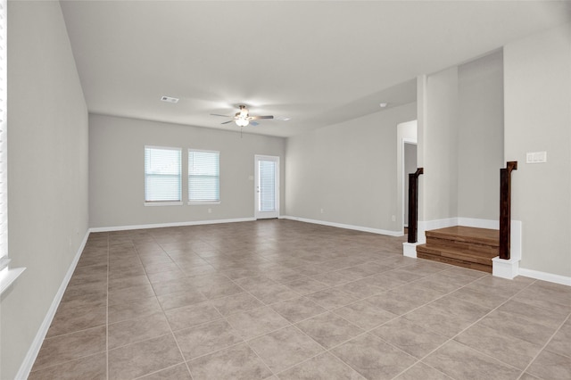 spare room with ceiling fan and light tile patterned flooring