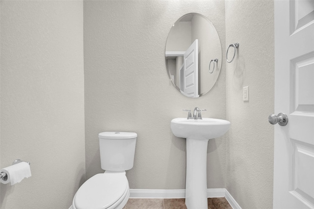 bathroom featuring toilet and tile patterned floors