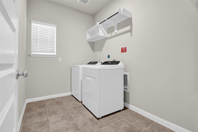 washroom featuring light tile patterned flooring and washing machine and clothes dryer