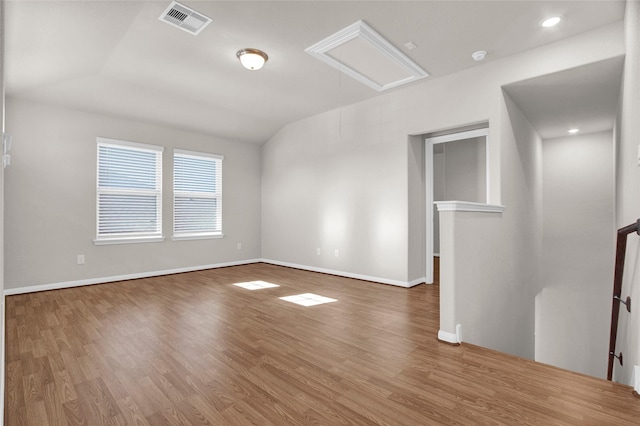 empty room with lofted ceiling and hardwood / wood-style flooring