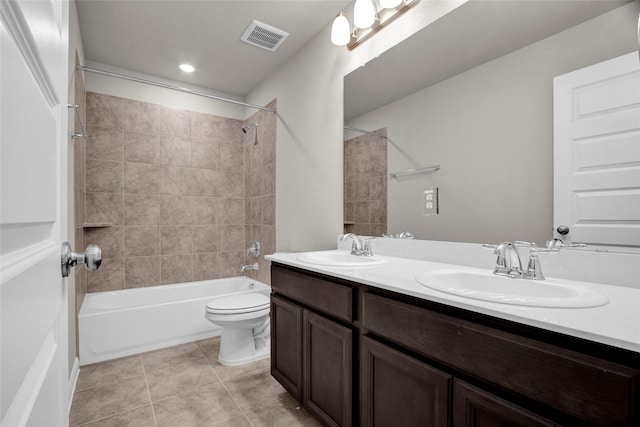 full bathroom featuring toilet, tiled shower / bath, tile patterned floors, and vanity