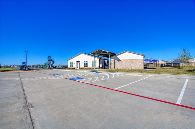 view of car parking with a playground