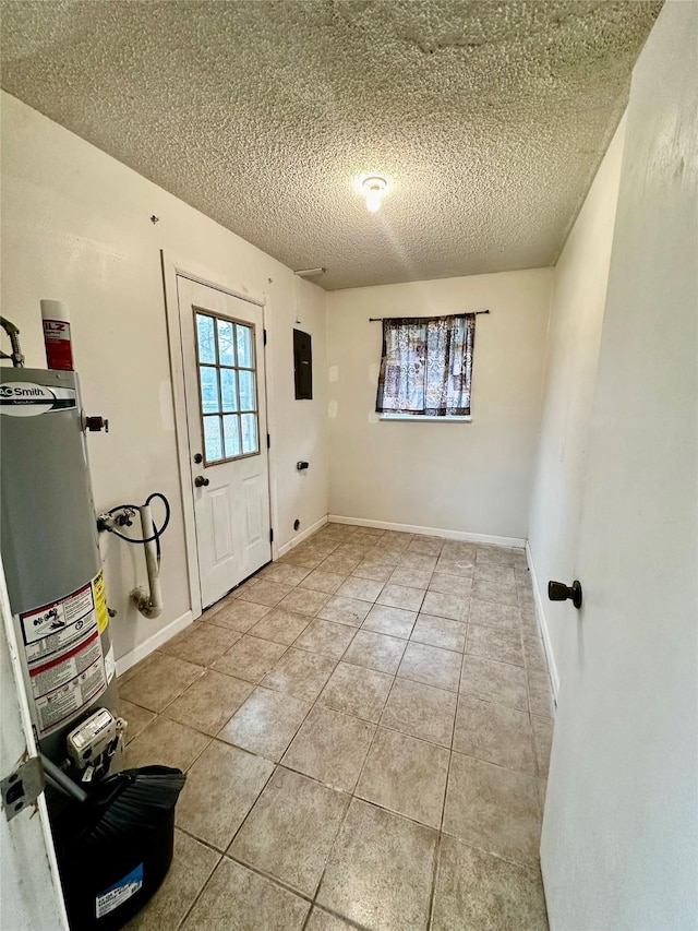 interior space with electric panel, a textured ceiling, water heater, and light tile patterned floors