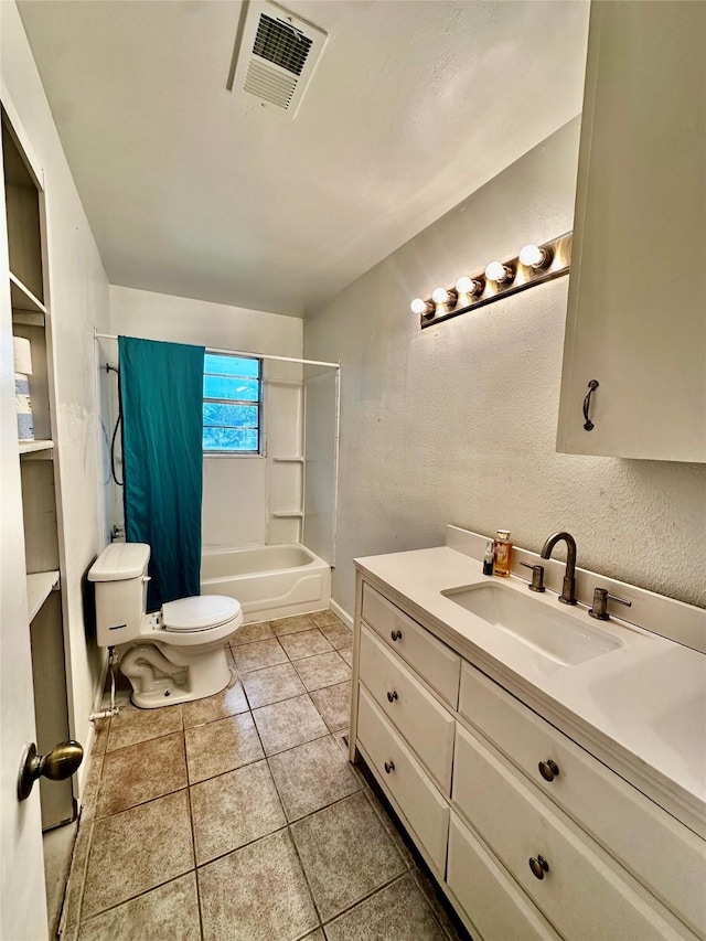 full bathroom featuring toilet, vanity, tile patterned floors, and shower / tub combination