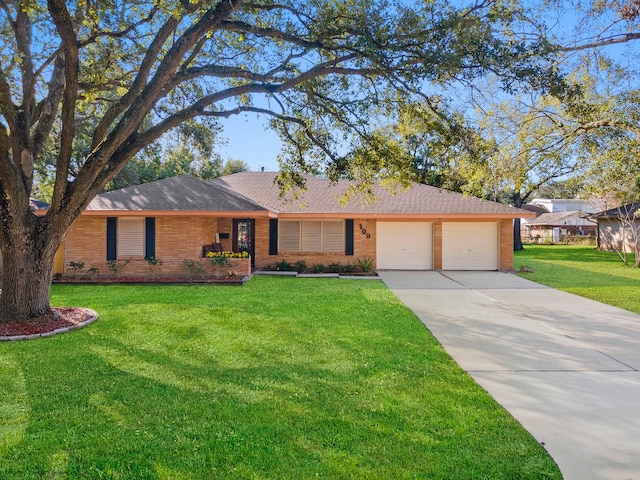 single story home featuring a garage and a front lawn