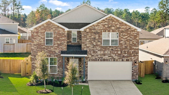 view of front of property featuring a front lawn and a garage