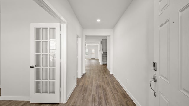 hallway with dark hardwood / wood-style flooring