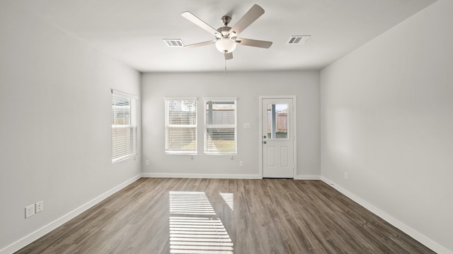 unfurnished room with wood-type flooring and ceiling fan