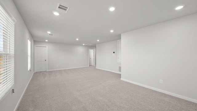 unfurnished room with light colored carpet