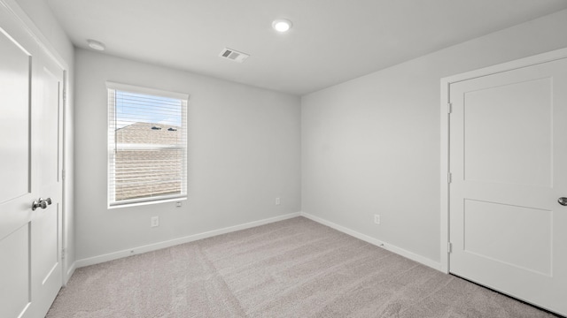 spare room with light colored carpet