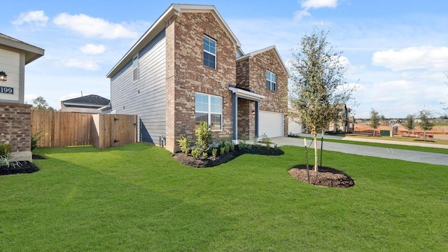 view of front of home featuring a front yard and a garage