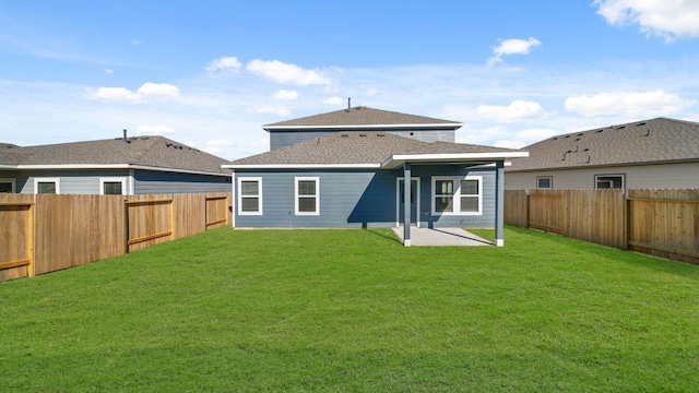 back of house with a patio area and a yard