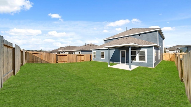 back of property featuring a patio area and a yard