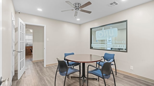 dining space with wood-type flooring and ceiling fan