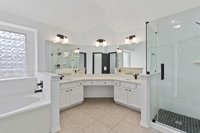 full bath featuring lofted ceiling, a garden tub, vanity, tile patterned floors, and a stall shower