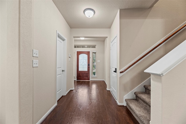 entrance foyer featuring a textured ceiling and dark hardwood / wood-style floors