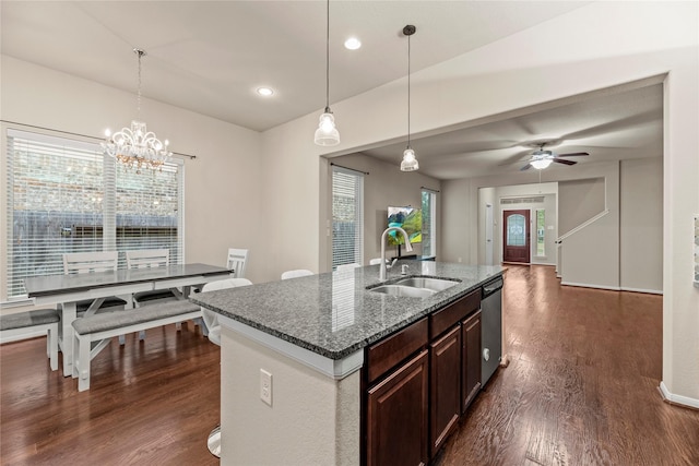 kitchen featuring stainless steel dishwasher, decorative light fixtures, ceiling fan with notable chandelier, dark brown cabinets, and sink