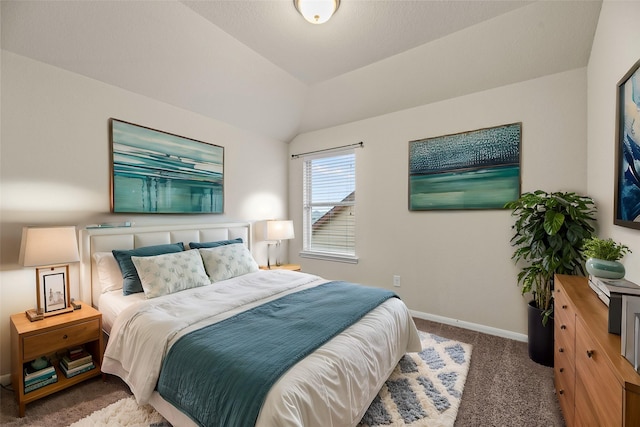 bedroom with lofted ceiling and dark carpet