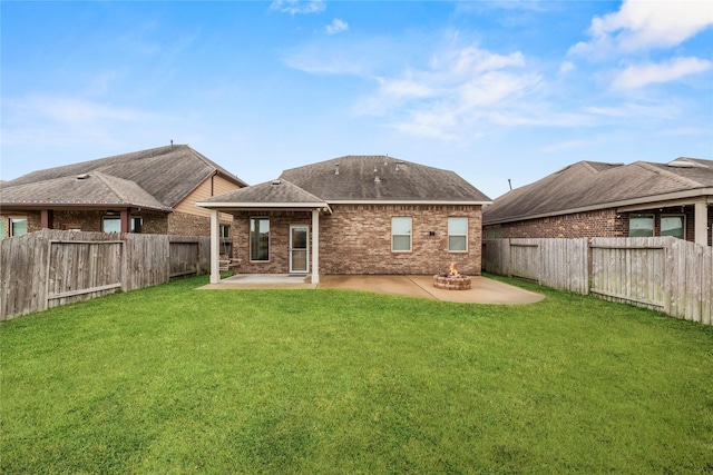 rear view of house featuring a patio area and a yard