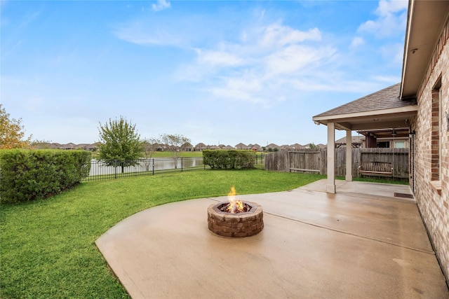 view of patio / terrace with an outdoor fire pit and a water view