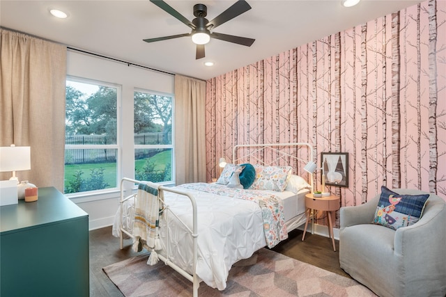 bedroom with ceiling fan and dark wood-type flooring