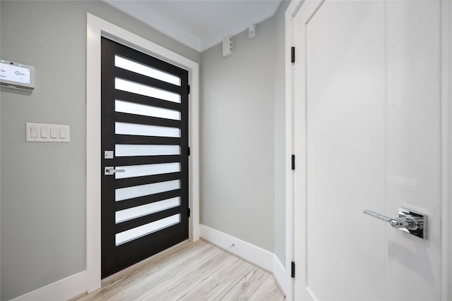 foyer entrance with light hardwood / wood-style floors