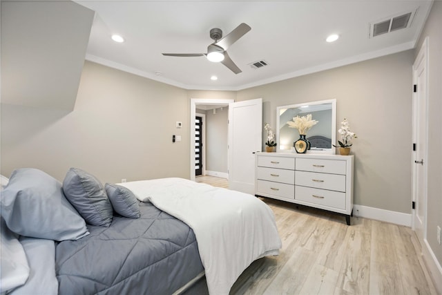 bedroom featuring ceiling fan, light hardwood / wood-style flooring, and crown molding