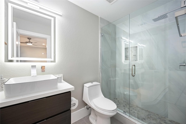 bathroom featuring toilet, walk in shower, vanity, and ceiling fan