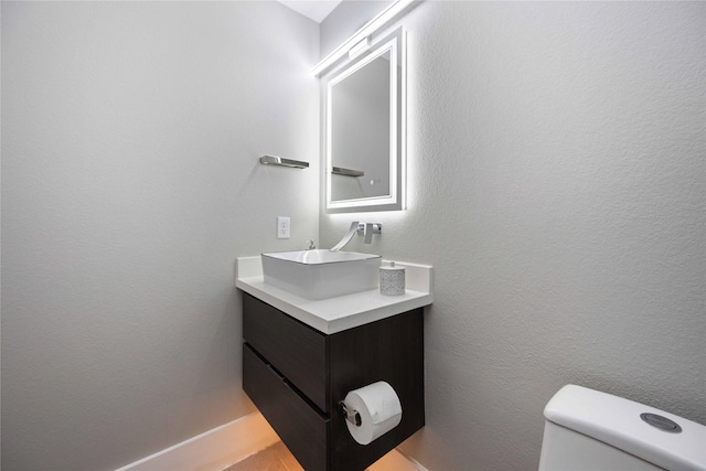 bathroom with toilet and vanity