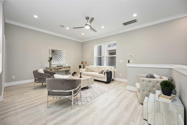 living room with ceiling fan, ornamental molding, and light hardwood / wood-style flooring