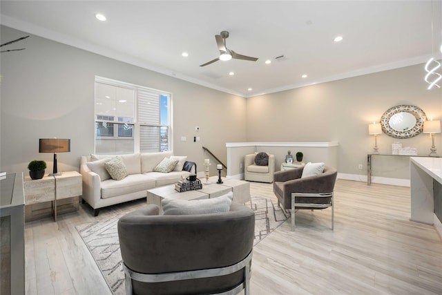 living room with light hardwood / wood-style floors, ceiling fan, and crown molding