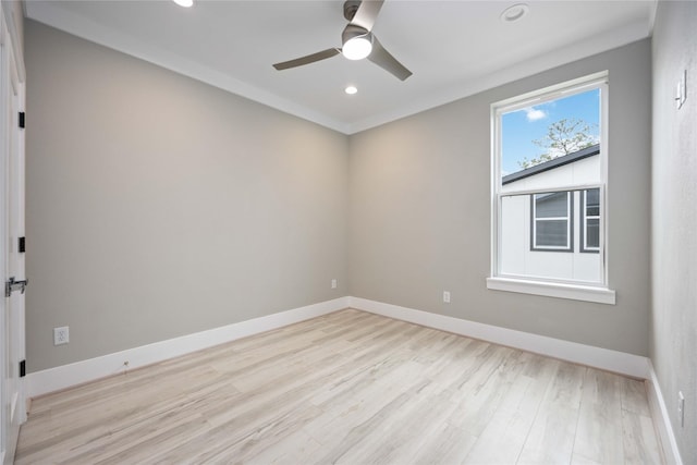 empty room with ceiling fan, light hardwood / wood-style flooring, and crown molding