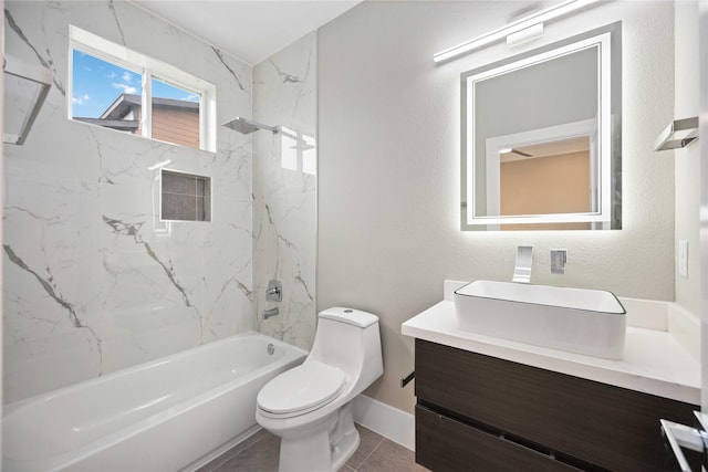 full bathroom with toilet, tile patterned flooring, tiled shower / bath, and vanity