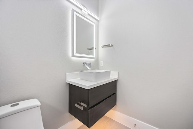 bathroom with toilet and vanity