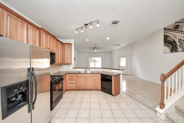 kitchen featuring black appliances, kitchen peninsula, ceiling fan, sink, and light tile patterned flooring