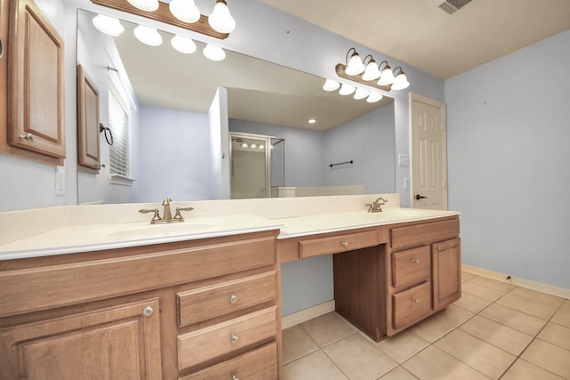 bathroom with vanity, an enclosed shower, and tile patterned flooring