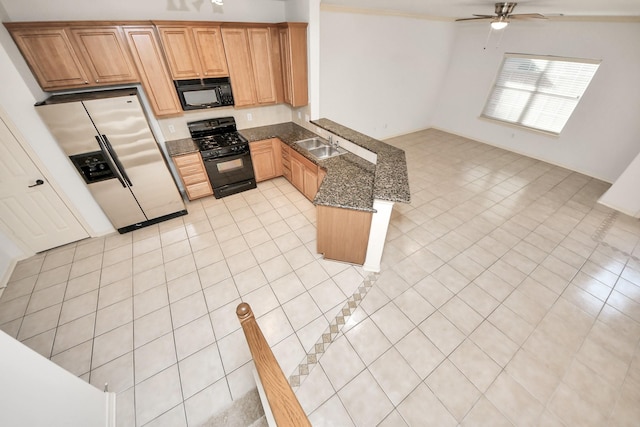 kitchen with dark stone counters, light tile patterned flooring, ceiling fan, and black appliances