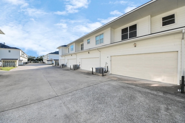 exterior space featuring cooling unit and a garage