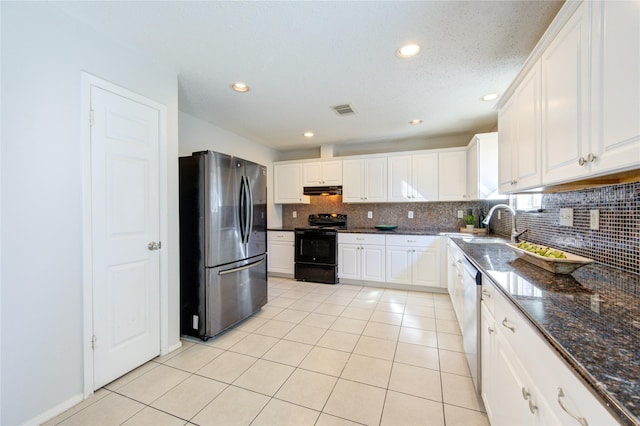 kitchen with white cabinets, appliances with stainless steel finishes, sink, and light tile patterned floors