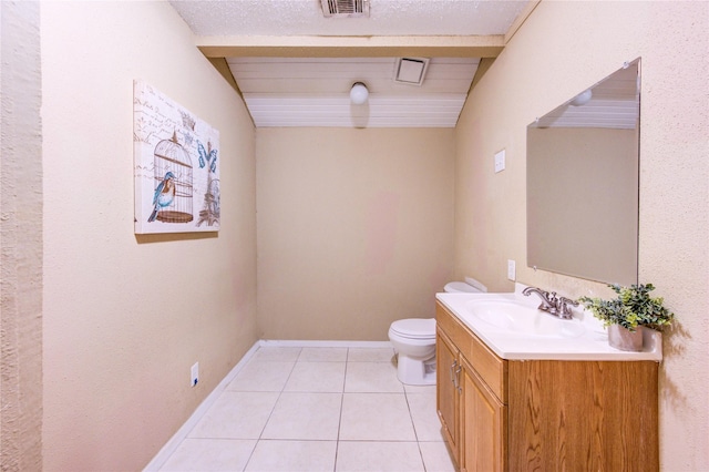 bathroom featuring toilet, vanity, tile patterned floors, and a textured ceiling