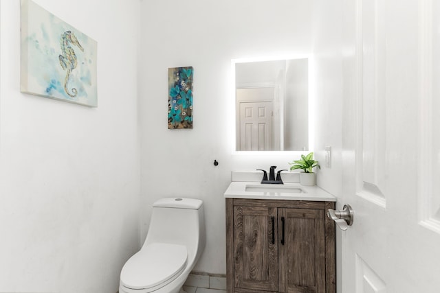 bathroom with toilet and vanity