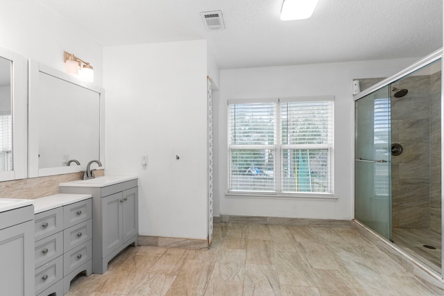 bathroom with vanity and walk in shower